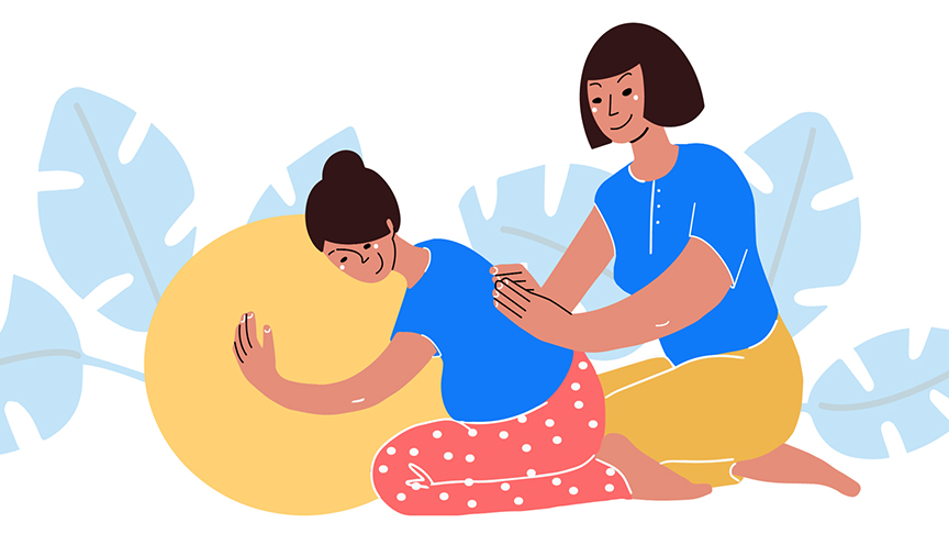 A midwife assists a pregnant woman sitting on the ground, highlighting a moment of care and support.