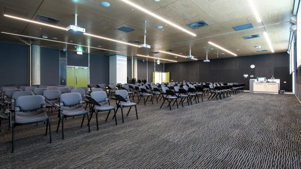 large room of chairs with projectors